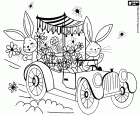 Zwei Osterhasen in einem Oldtimer verteilen Blumen, um Ostern zu feiern